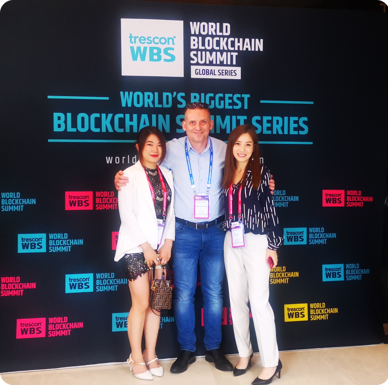 People standing in front of conference wall